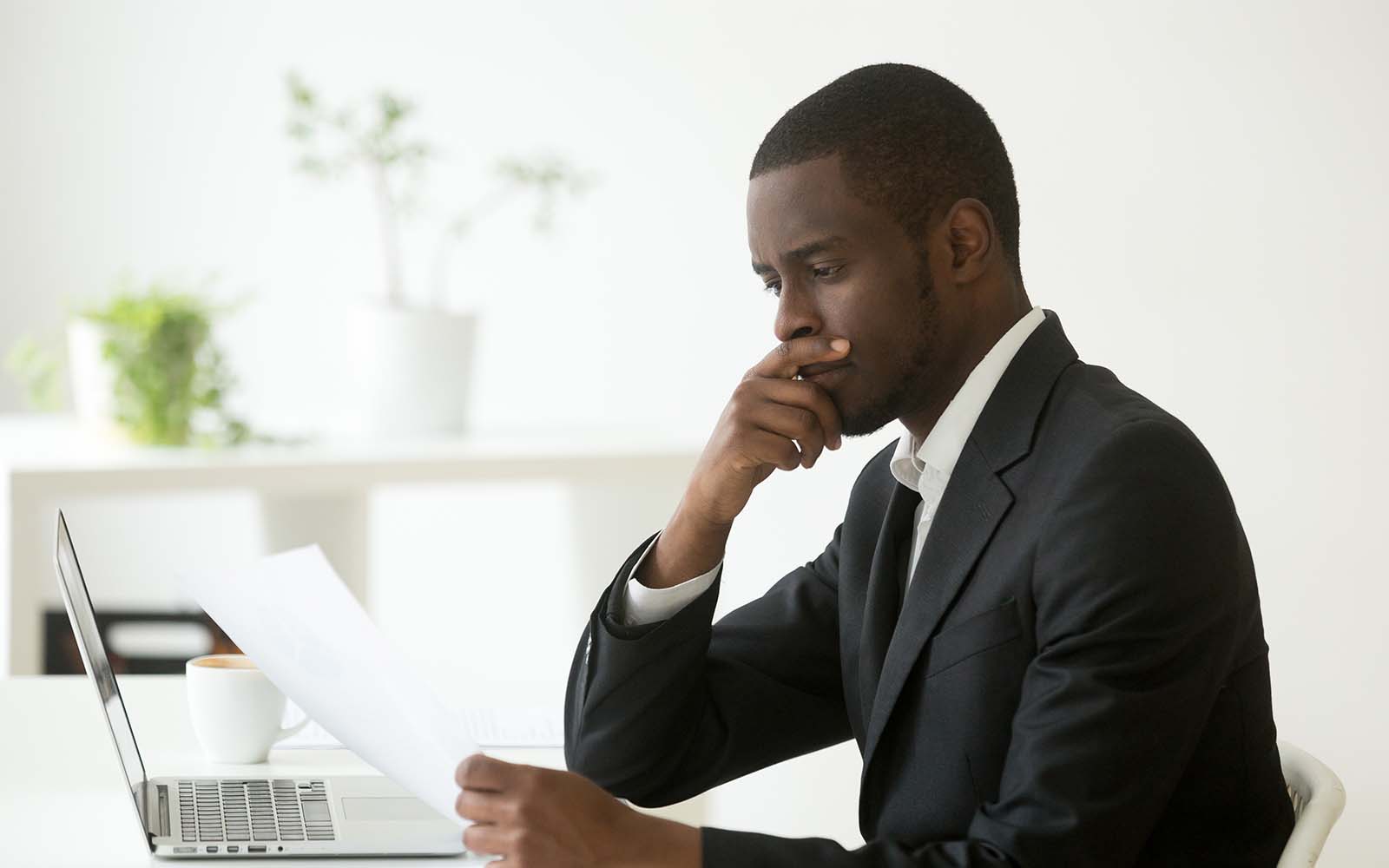 Businessman employer thinking of business reading letter at workplace