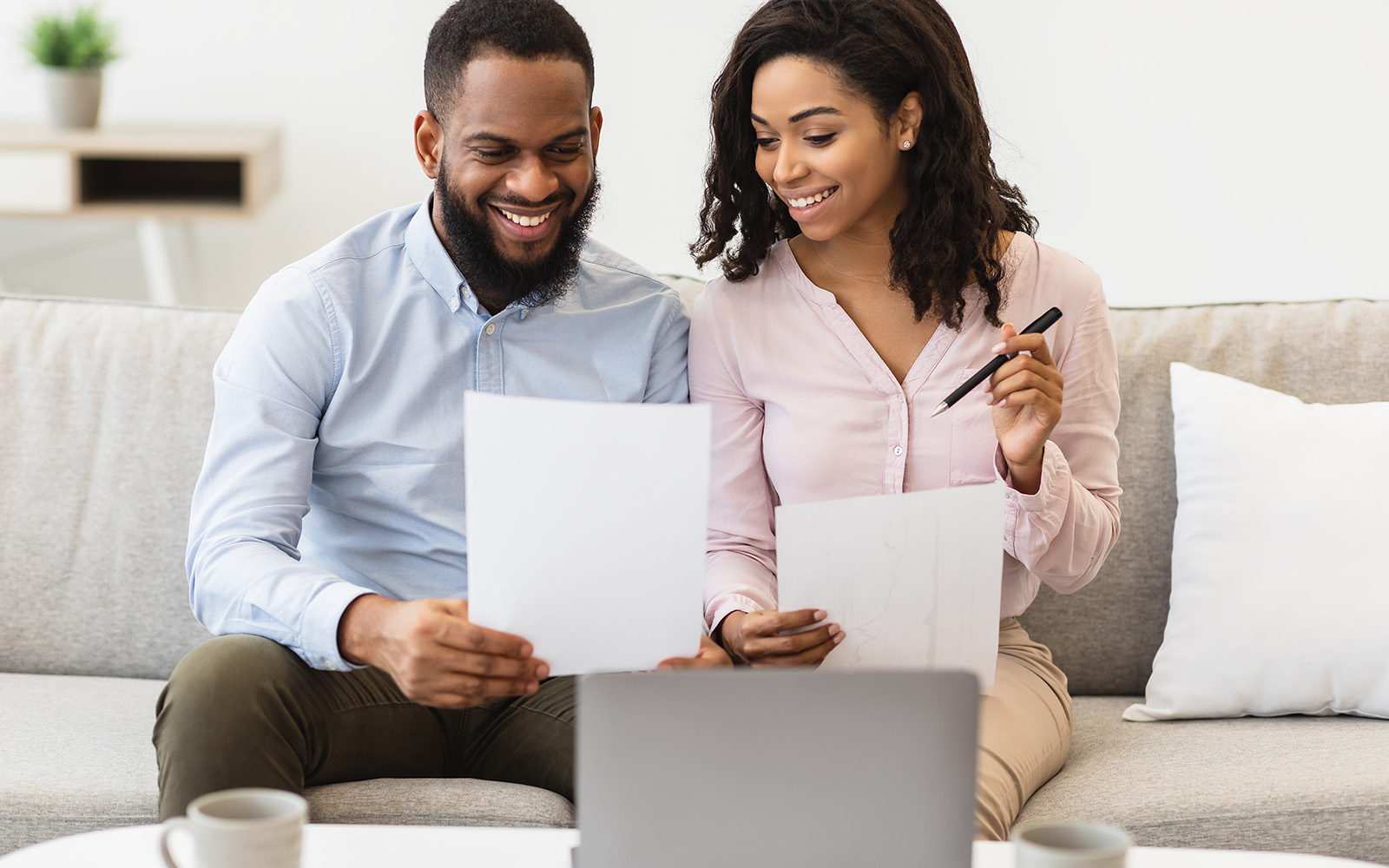 Man and woman sitting down, looking at his sheet of paper