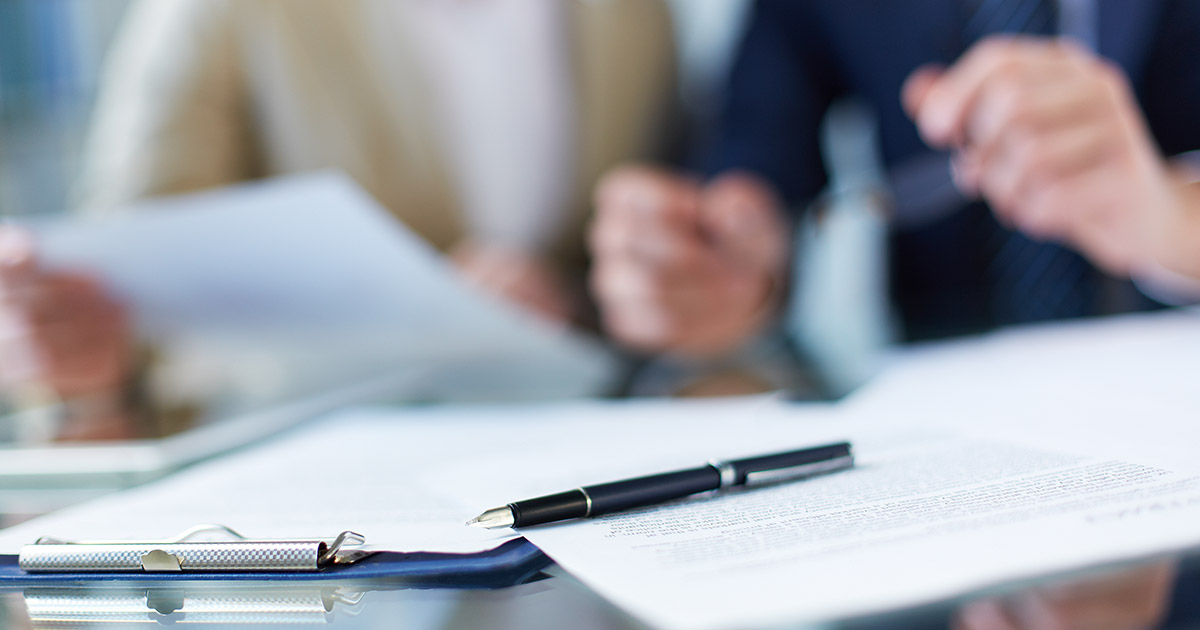 Business documents and pen on a desk