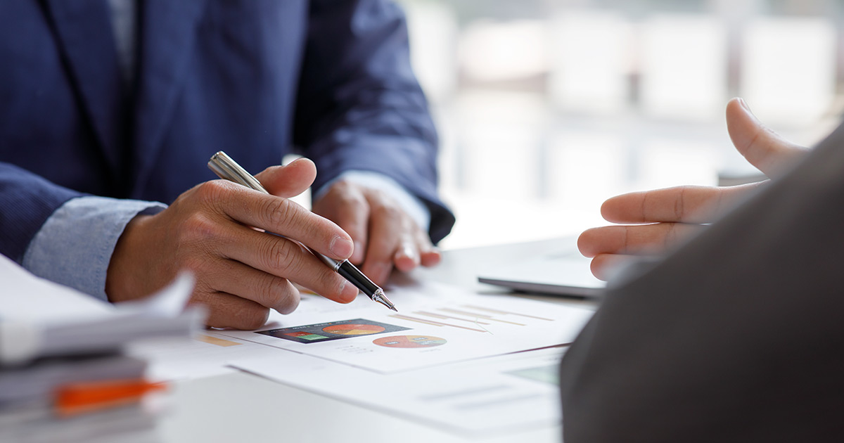 Business person sitting at a desk reviewing documents