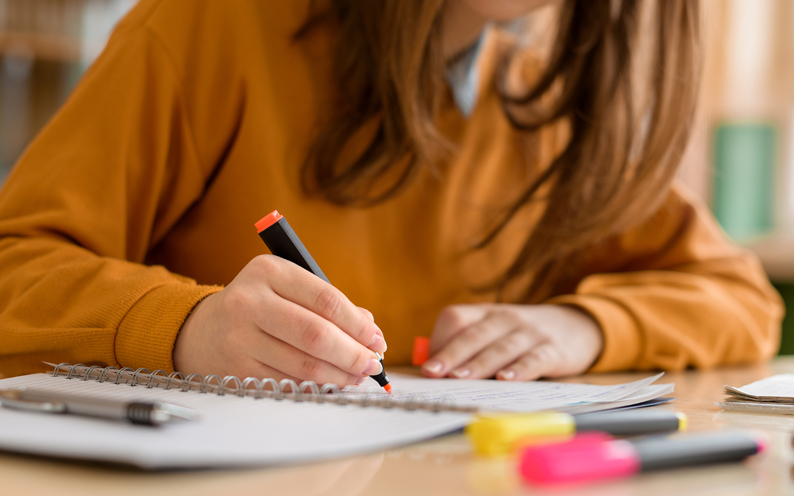 person using highlighter on paper