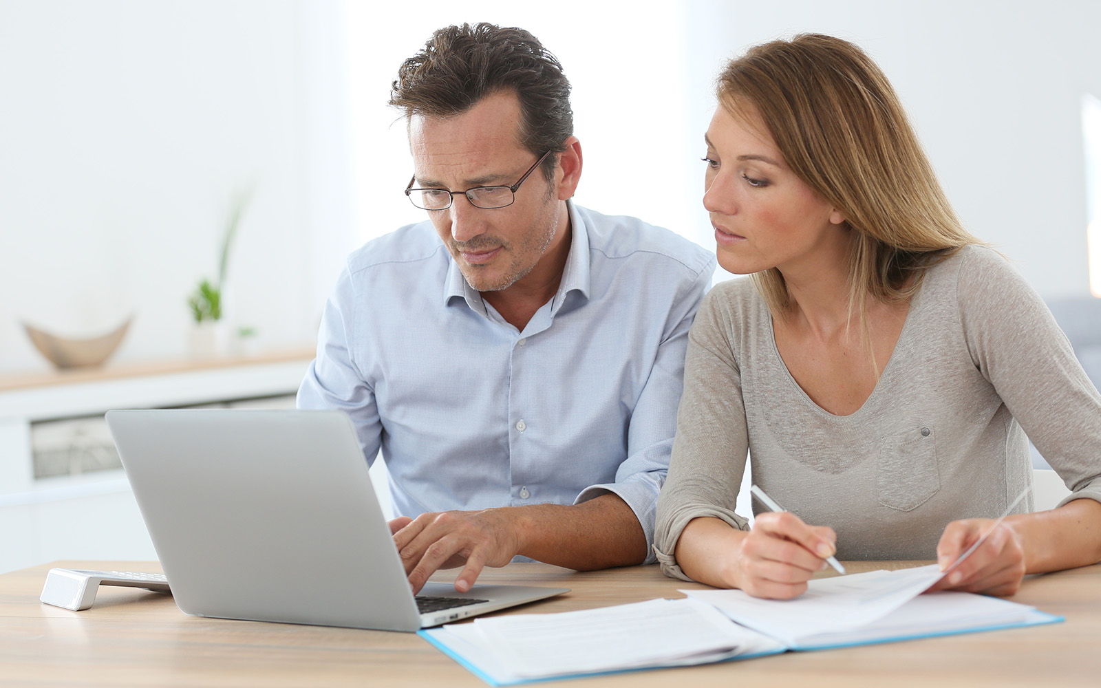 Couple at home working on laptop computer