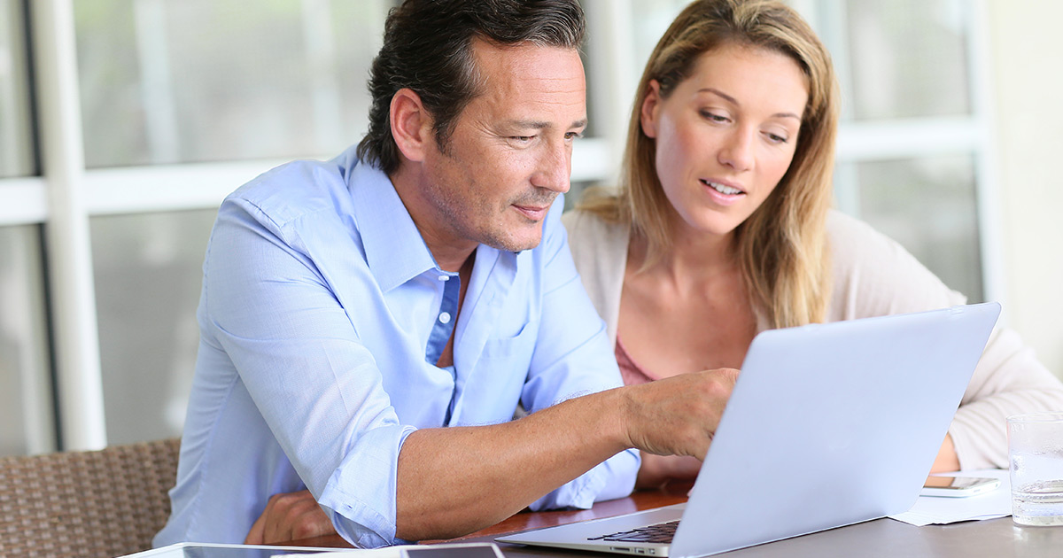 couple working together on laptop computer