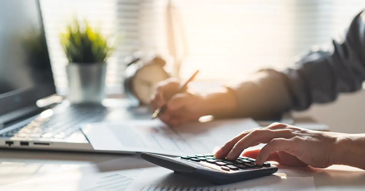 Businessperson calculating financials on calculator