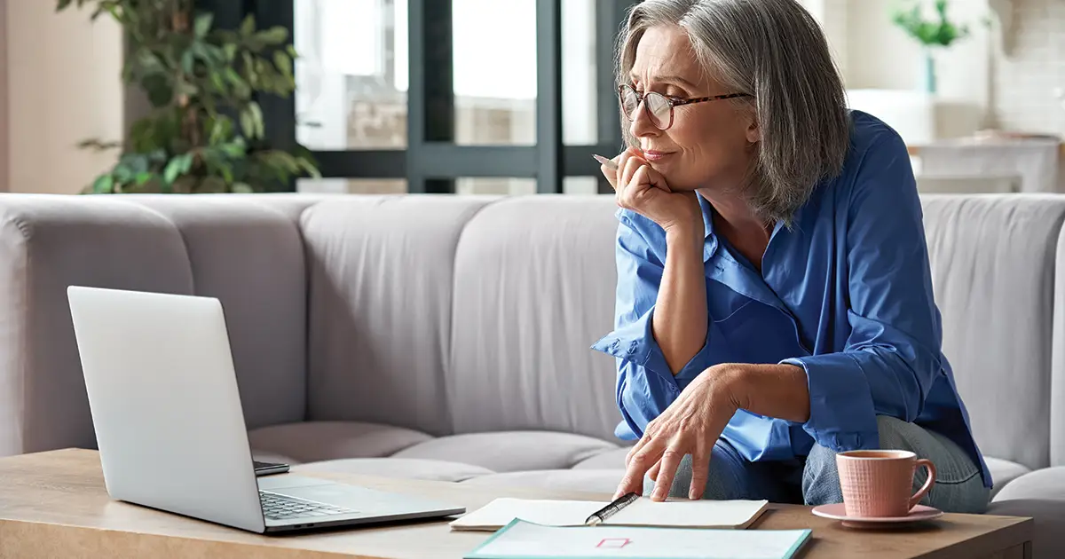 mature woman viewing information online on a computer copy