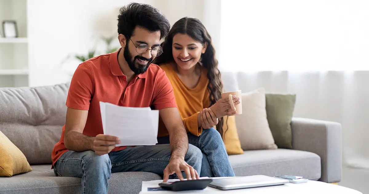 Spouses Checking Financial Documents And Calculating Family Budget At Home