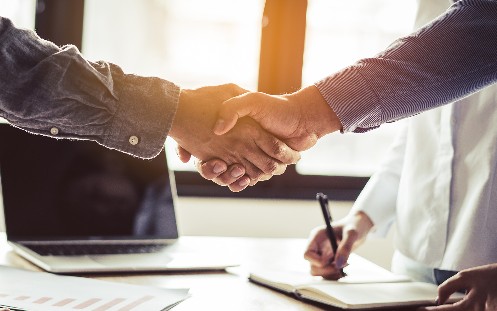 Two businessmen handshaking in meeting after final agreement done