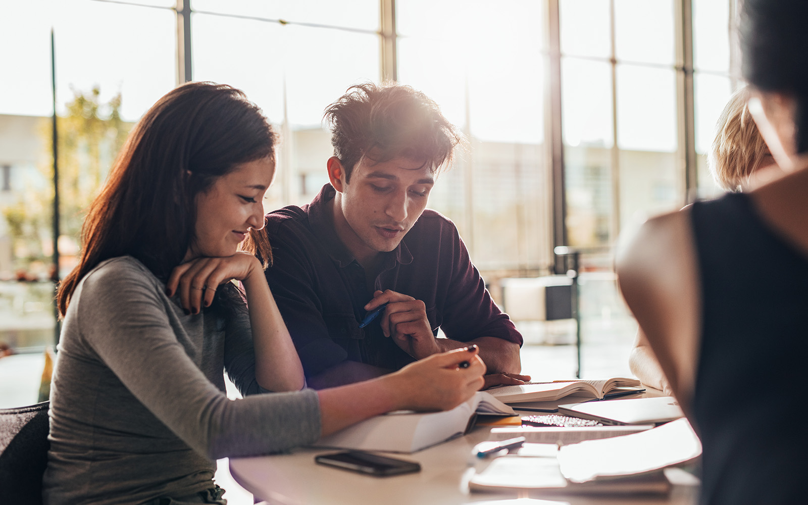 two people sitting at a table reviewing documents