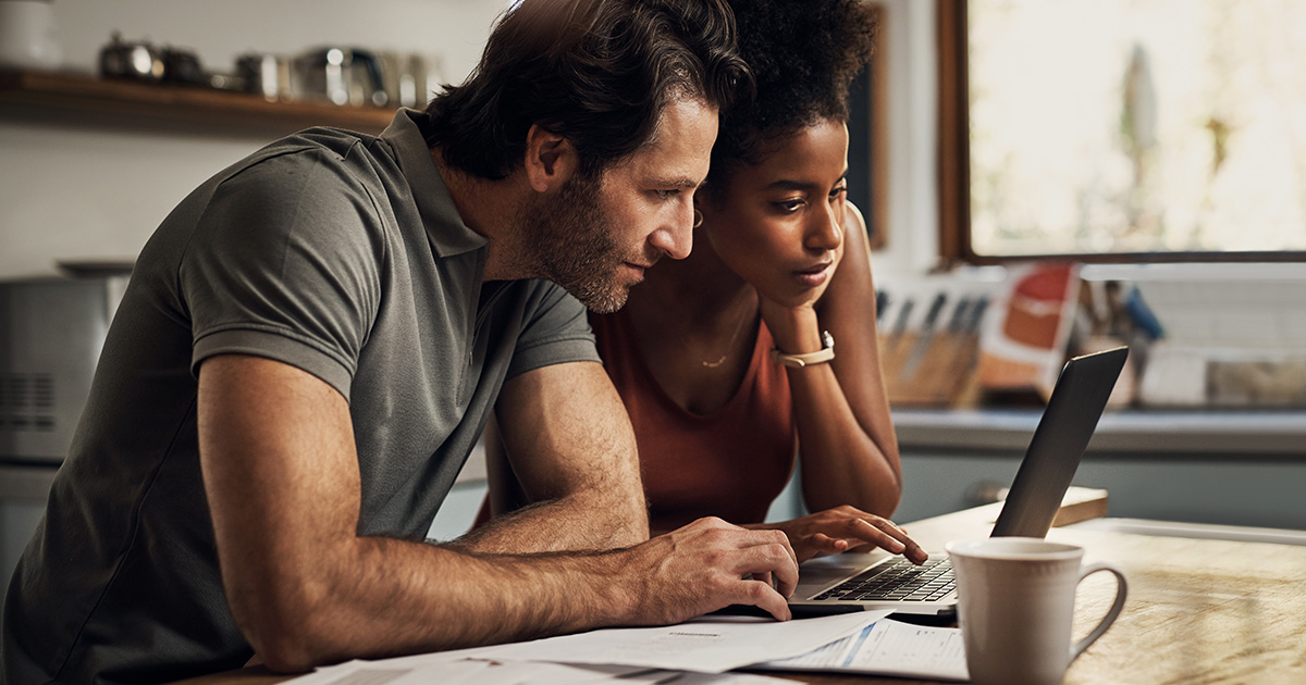 Two serious people planning and looking at financial document bills rate for mortgage