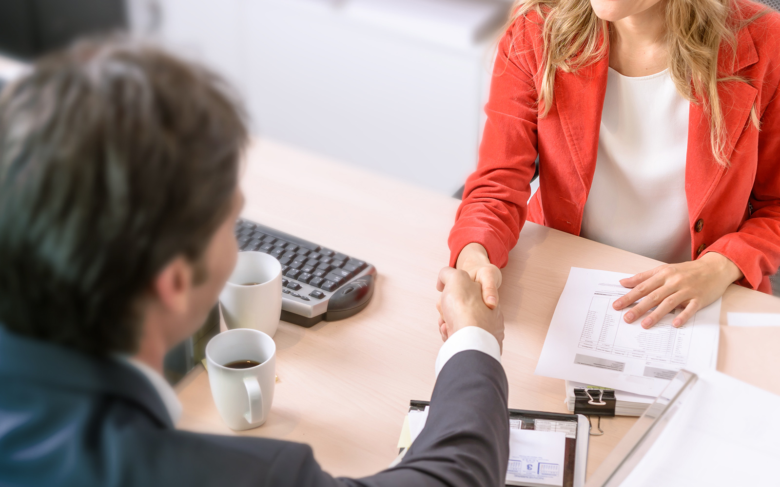 Male and female business people shaking hands