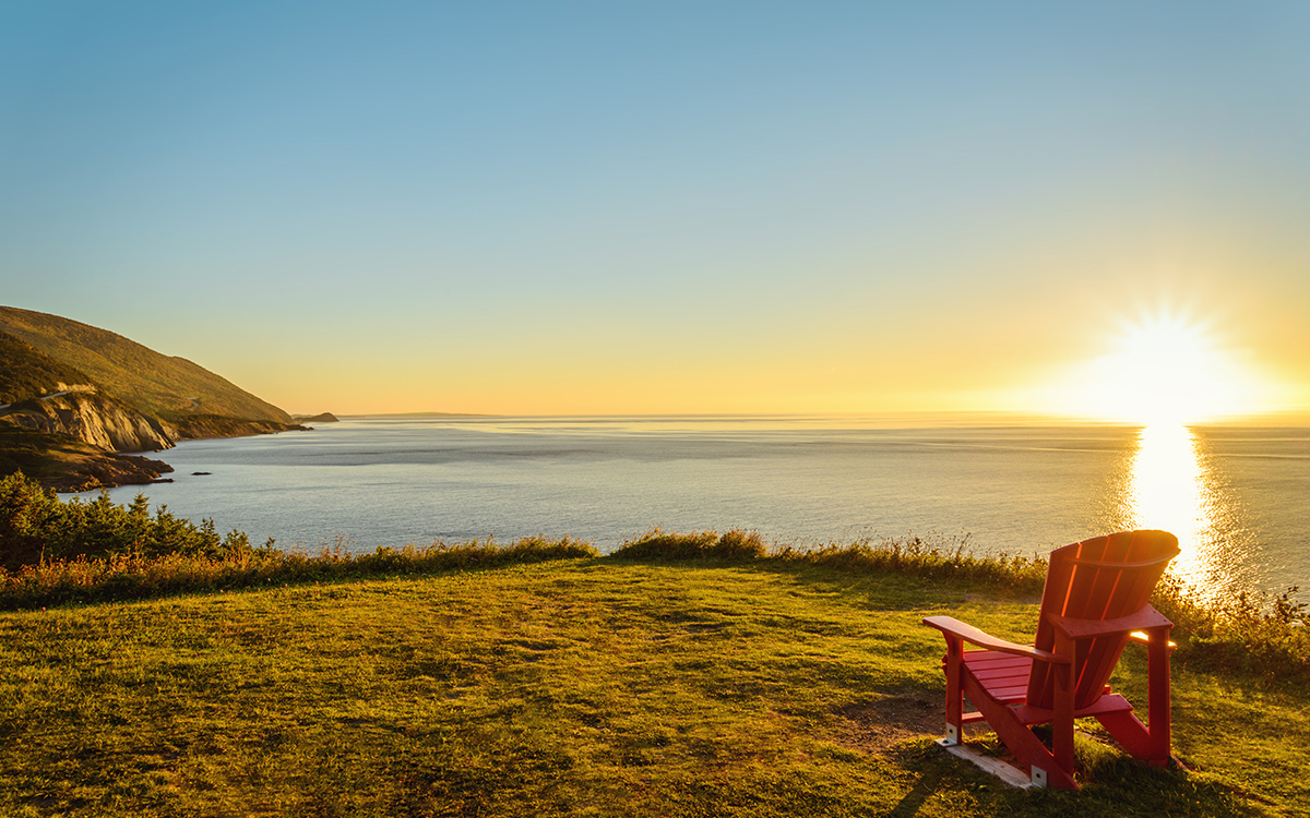 chair on a hill facing the sunset