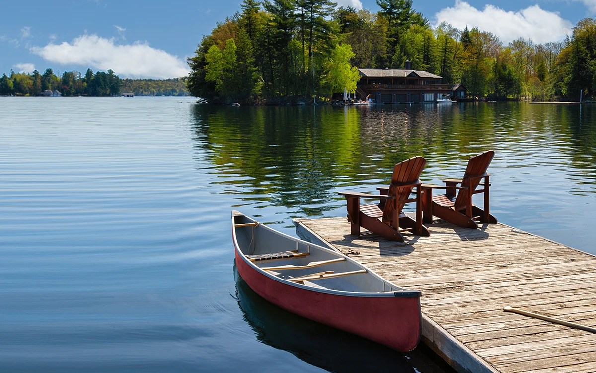 Image of canoe beside a dock on a lake