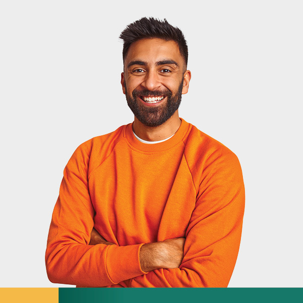 Young man in orange shirt smiling