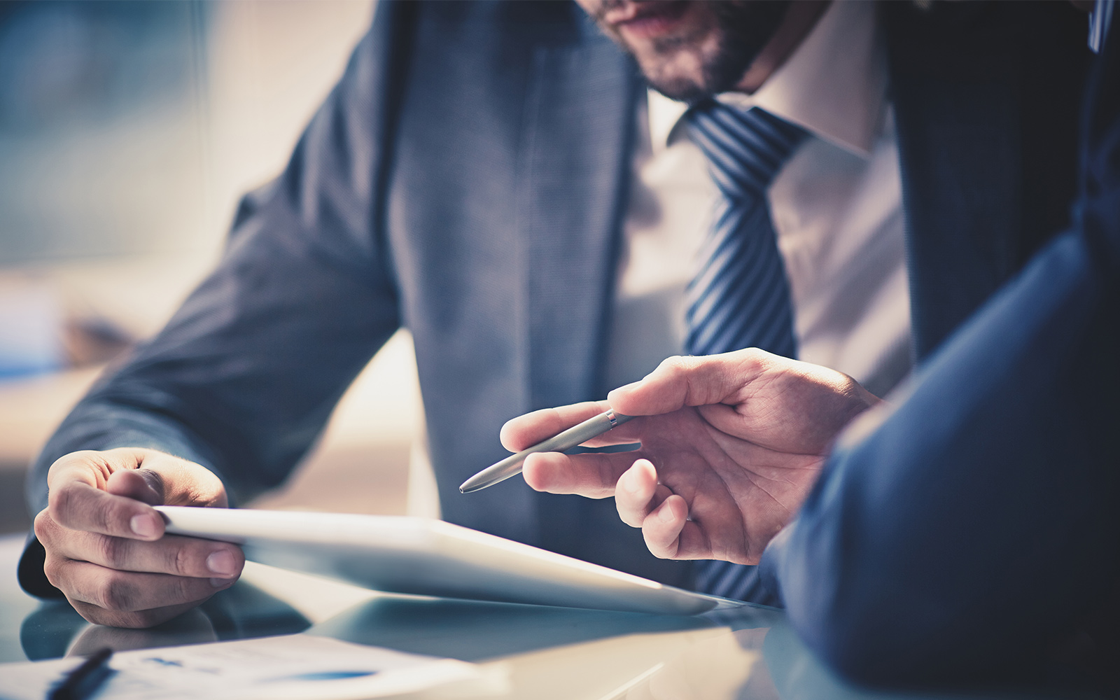 Business people using touchpad at meeting