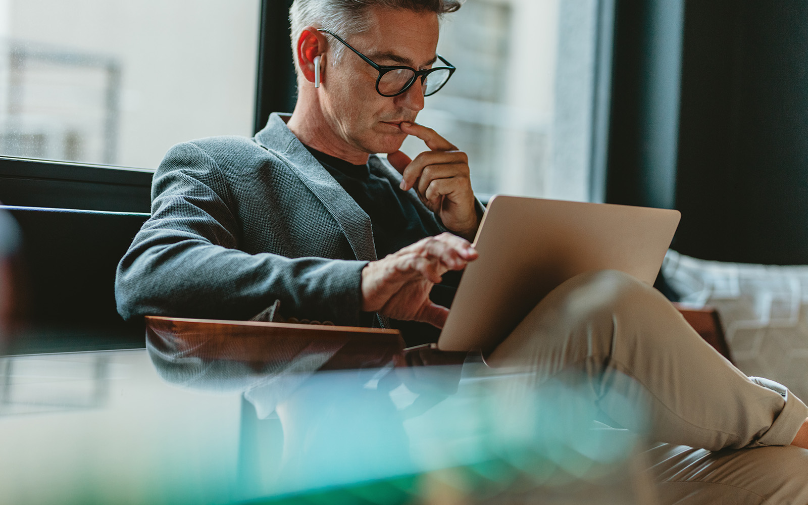 Man looking at laptop and thinking