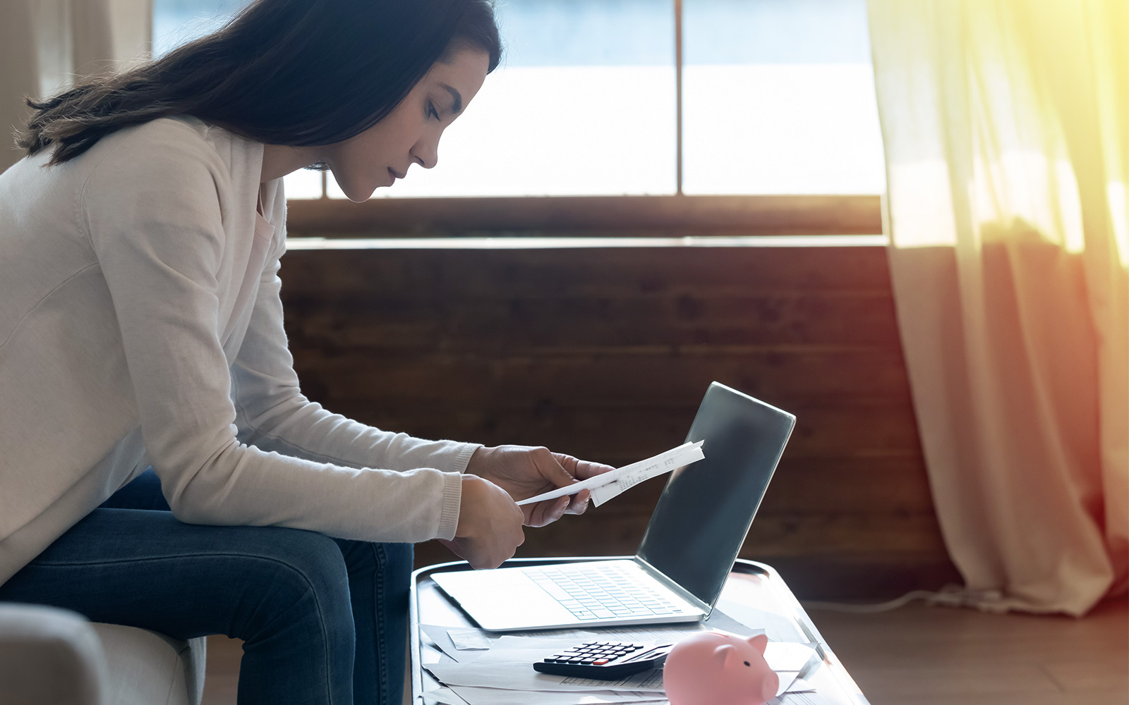 Side shot of concentrated young lady working with financial documents