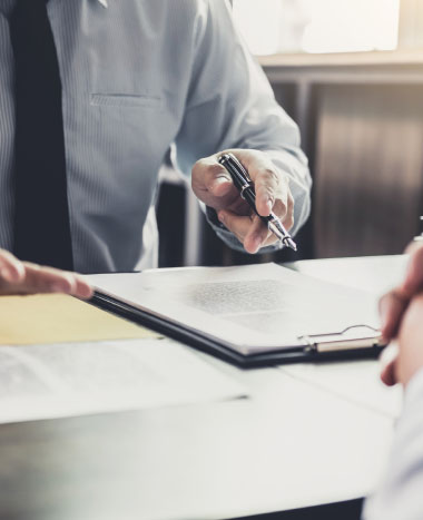 two people having a conversation with paperwork on the table